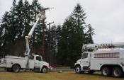 Two power trucks installing a high voltage line
